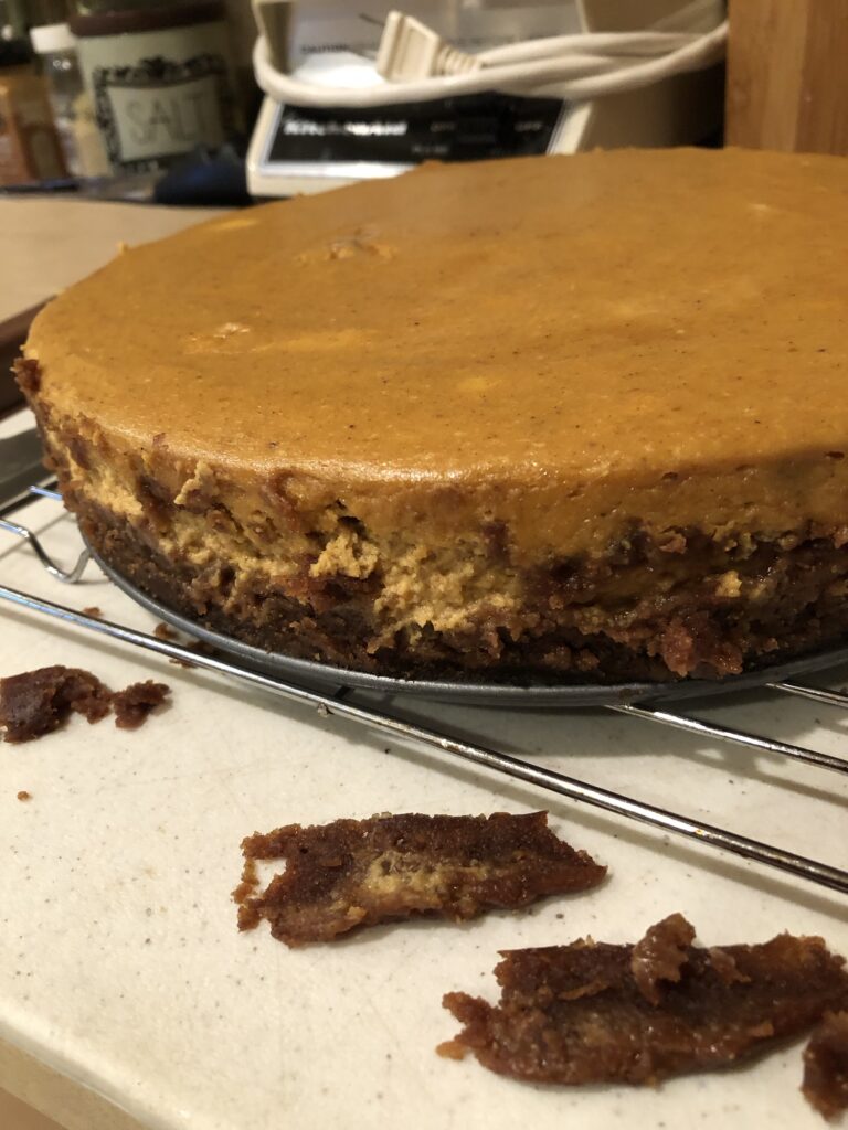 Gross soggy crust cut away from the sides of the cheesecake